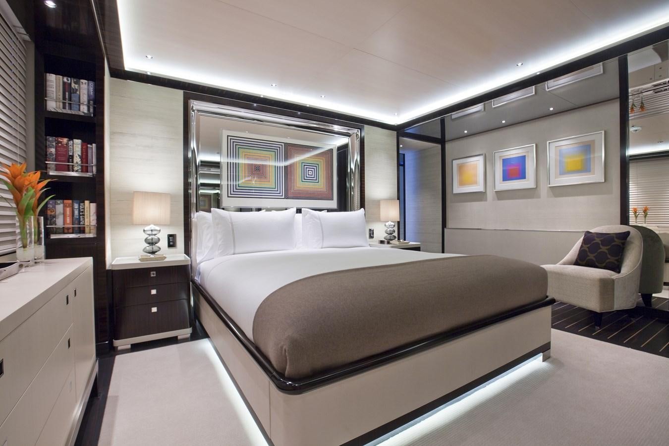 a bedroom with a bed and a couch aboard KAHALANI Yacht for Sale