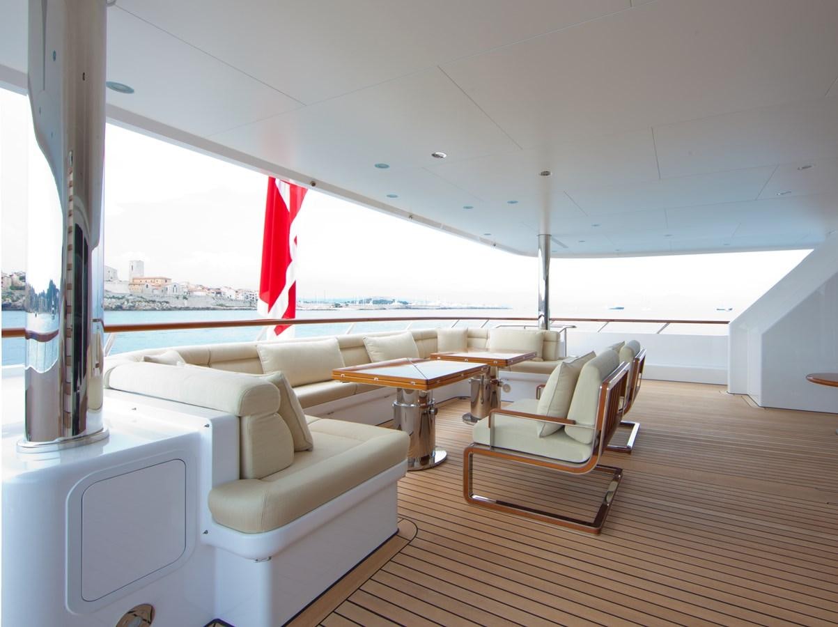 a room with a table chairs and a window aboard KAHALANI Yacht for Sale