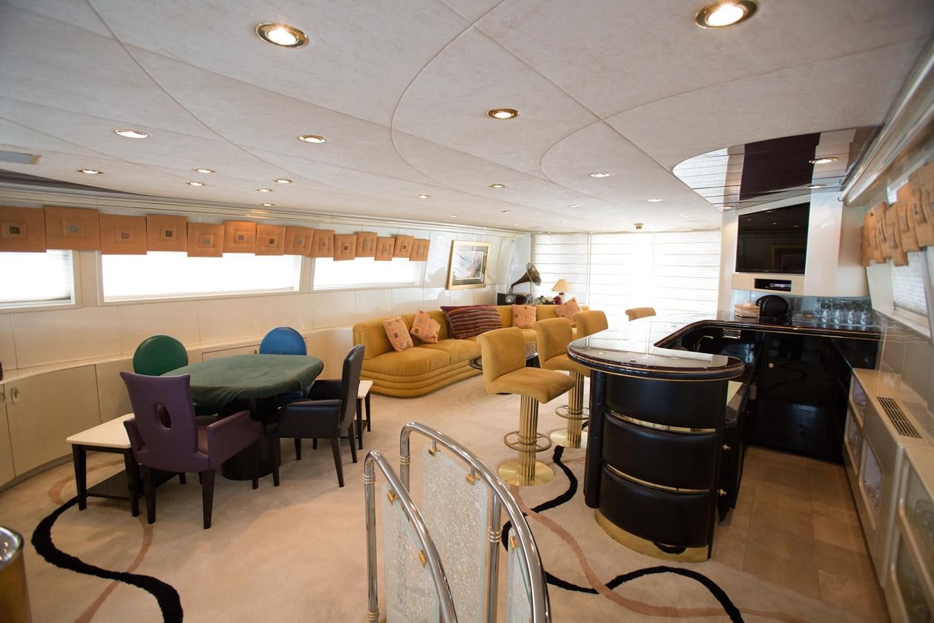 a room with tables and chairs aboard TAMTEEN Yacht for Sale
