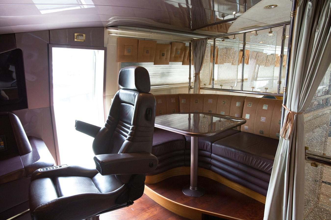 a room with a table and chairs aboard TAMTEEN Yacht for Sale