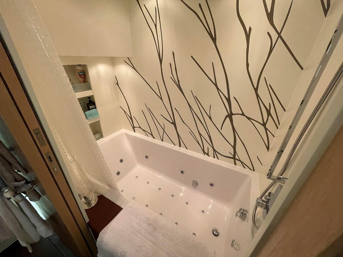 a bathtub with a shower curtain aboard ESPRESSO Yacht for Sale