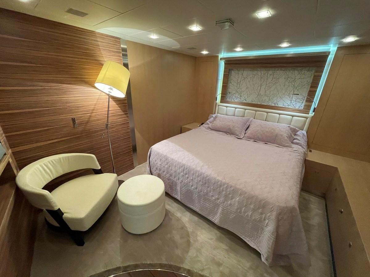 a room with a bed and a chair aboard ESPRESSO Yacht for Sale