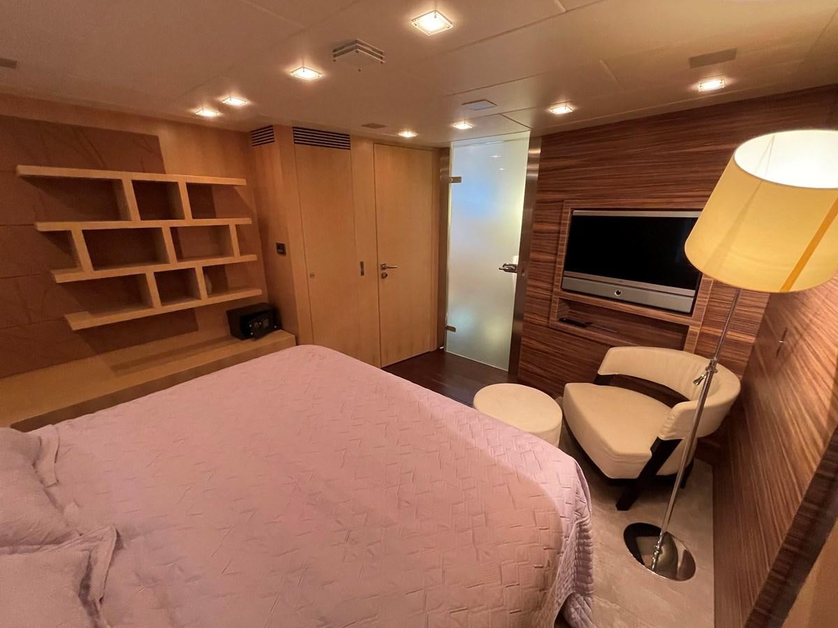 a bedroom with a bed and a tv aboard ESPRESSO Yacht for Sale
