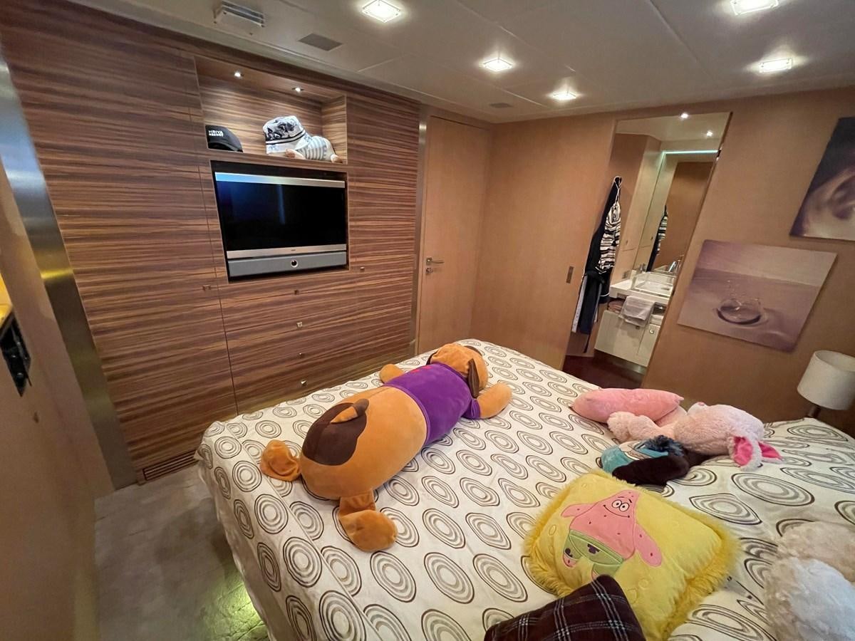 a bedroom with a bed and a tv aboard ESPRESSO Yacht for Sale
