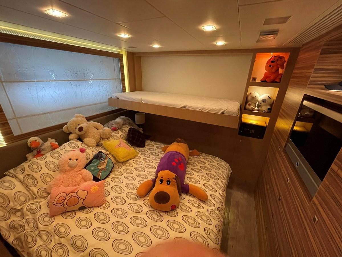 a bedroom with stuffed animals aboard ESPRESSO Yacht for Sale