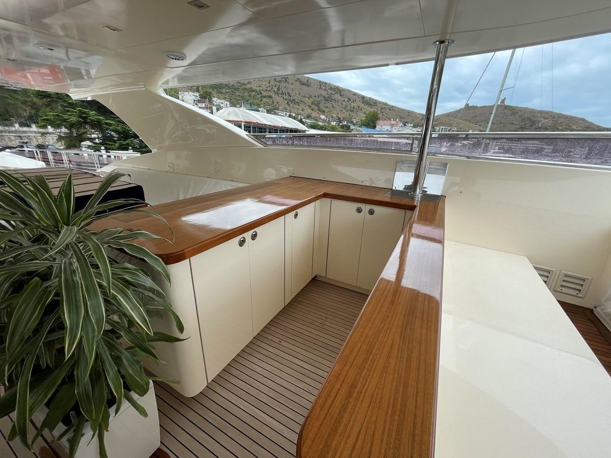 a room with a wood floor and a large window with a view of a city aboard ESPRESSO Yacht for Sale