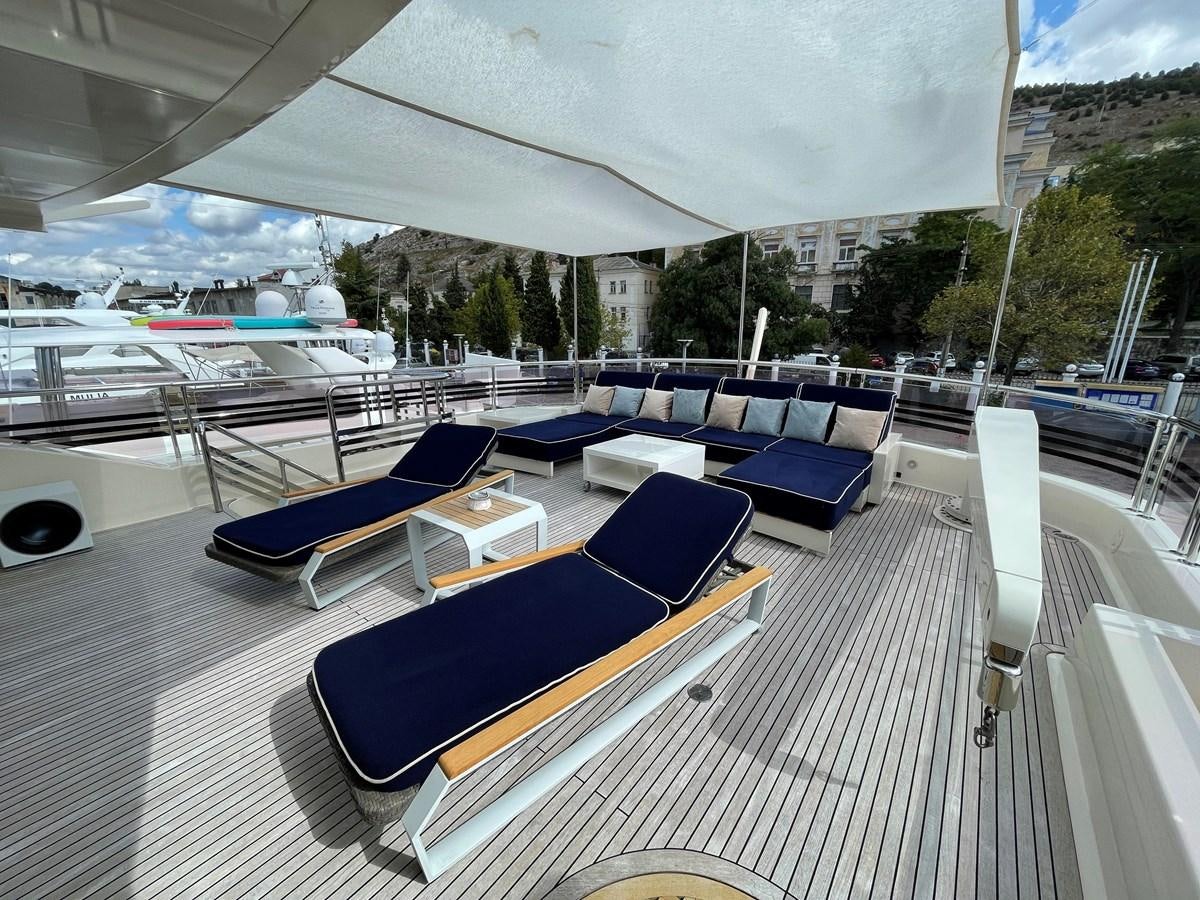 a large lounge area with lounge chairs and a pool aboard ESPRESSO Yacht for Sale