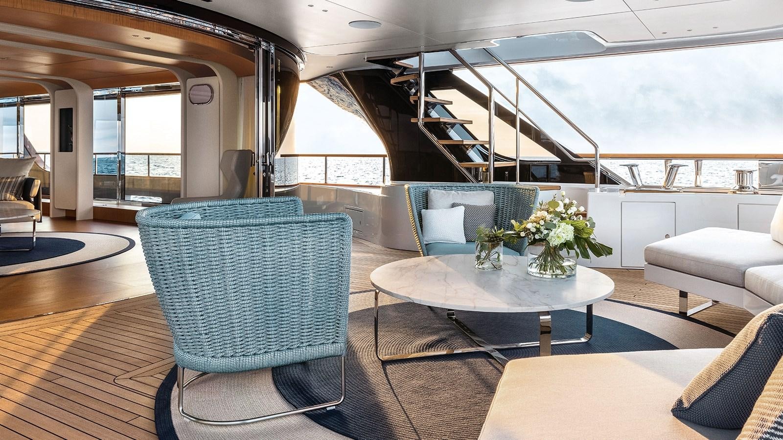 a room with a table and chairs aboard KOJU Yacht for Sale