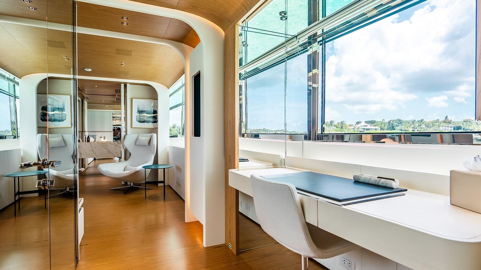 a room with a table and chairs aboard KOJU Yacht for Sale