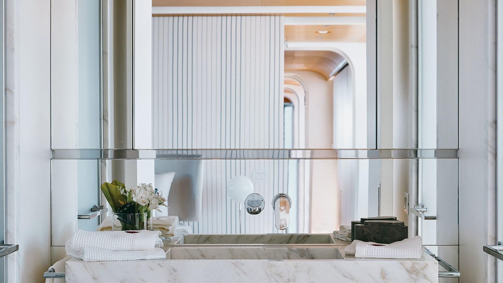 a bathroom with a large mirror aboard KOJU Yacht for Sale