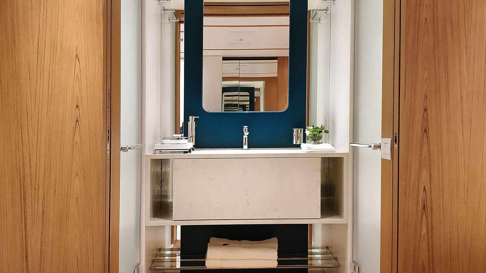 a bathroom with a sink and a mirror aboard KOJU Yacht for Sale