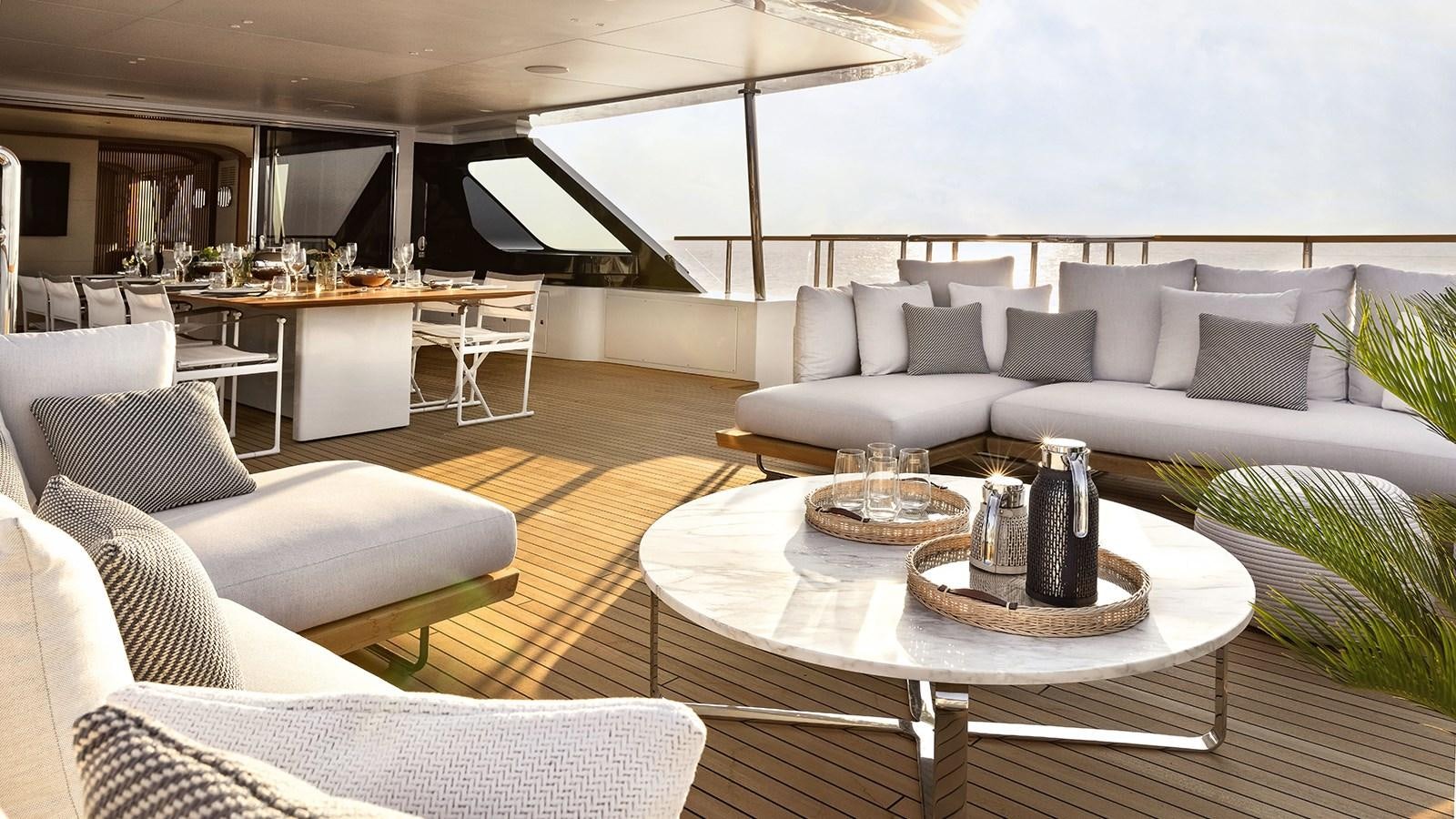 a living room with a couch and a table aboard KOJU Yacht for Sale