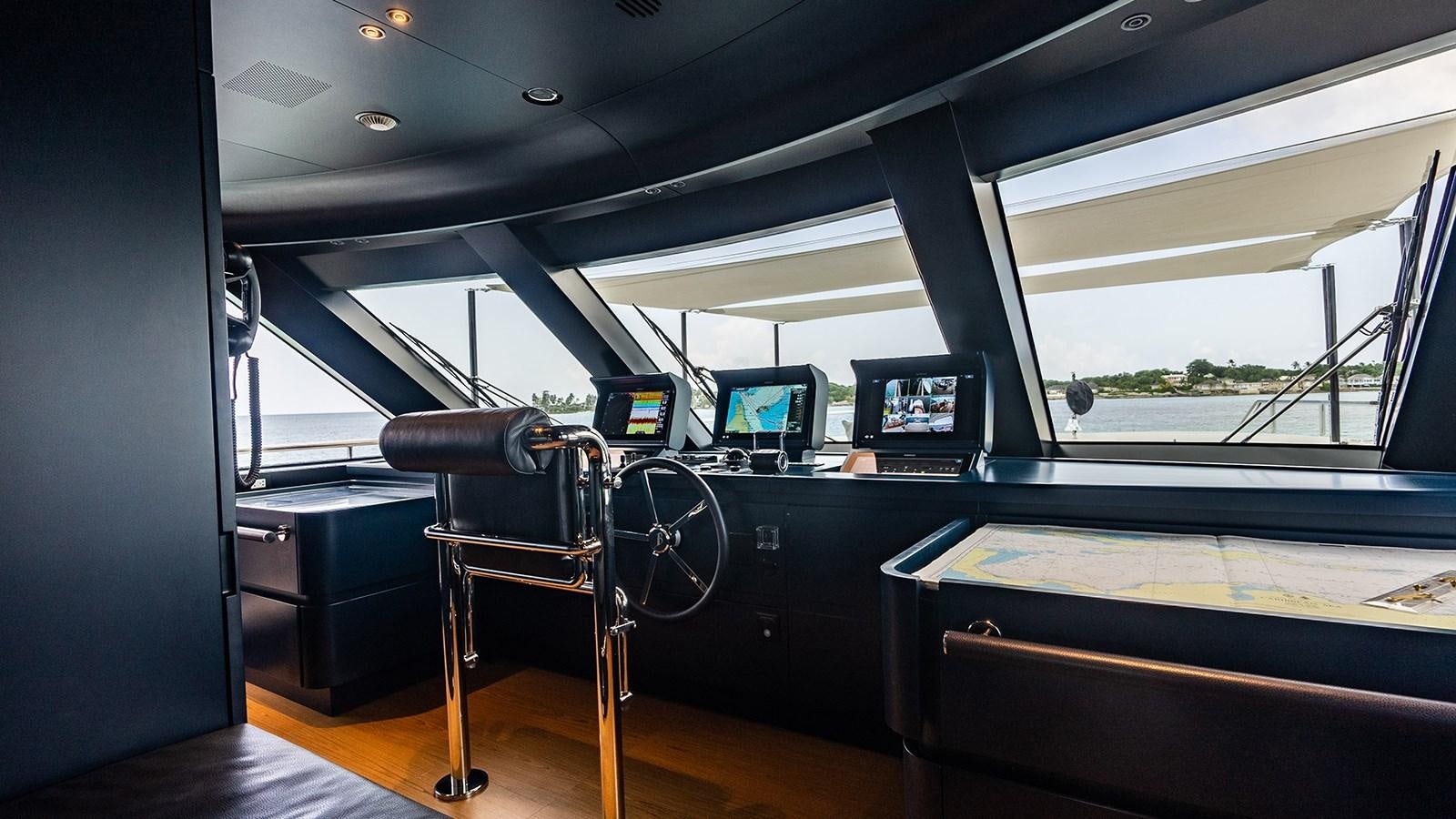a black chair in a room aboard KOJU Yacht for Sale