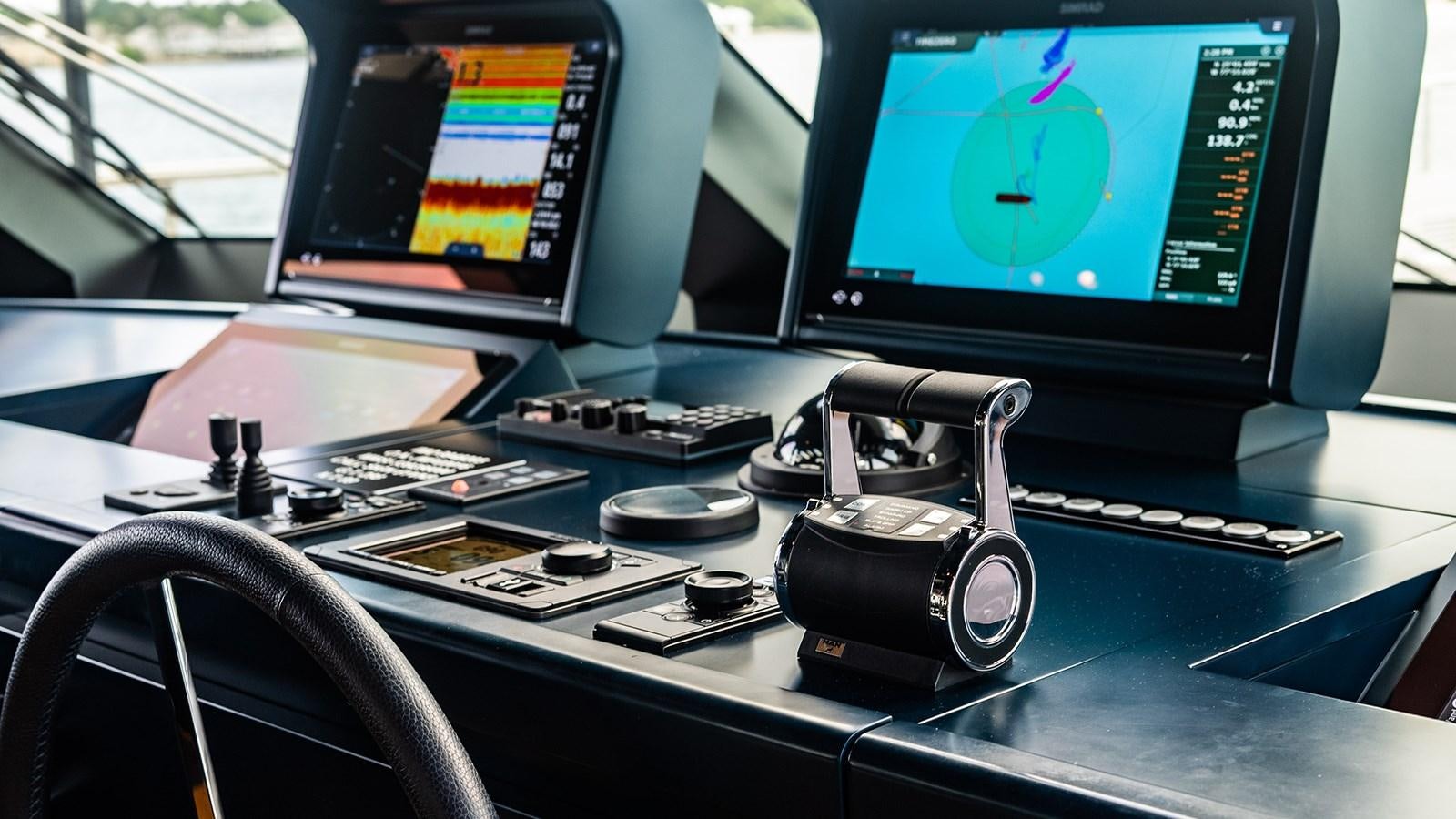 a desk with a computer and a monitor aboard KOJU Yacht for Sale