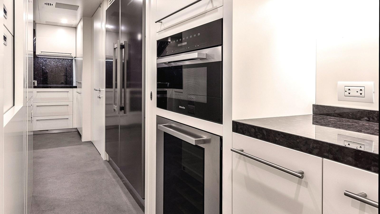 a kitchen with a stove and oven aboard KOJU Yacht for Sale