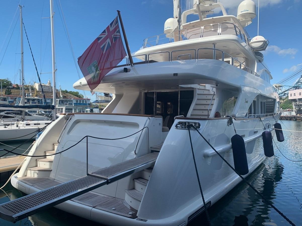 a large white boat with a flag on it aboard DREAM ON II Yacht for Sale