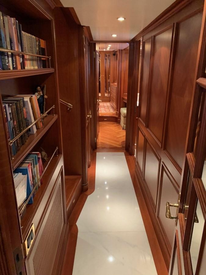 a hallway with a bookshelf aboard DREAM ON II Yacht for Sale