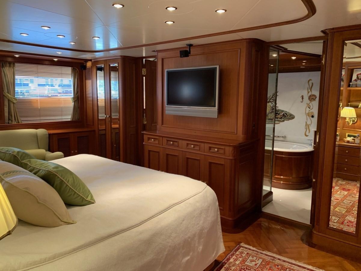 a bedroom with a bed and a television aboard DREAM ON II Yacht for Sale