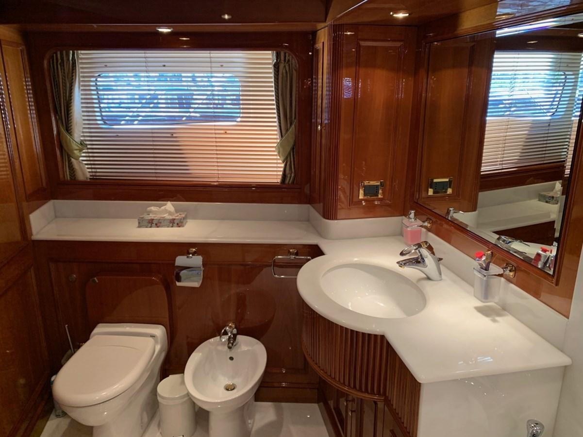 a bathroom with a sink toilet and a large window aboard DREAM ON II Yacht for Sale