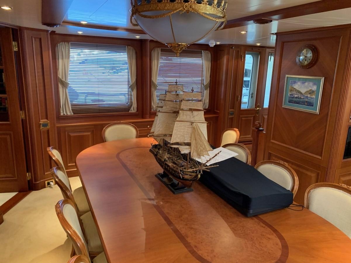 a living room with a large table aboard DREAM ON II Yacht for Sale