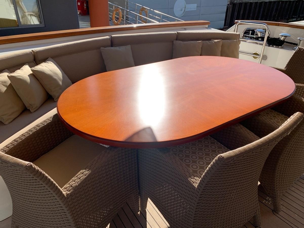 a round table with a chair aboard DREAM ON II Yacht for Sale