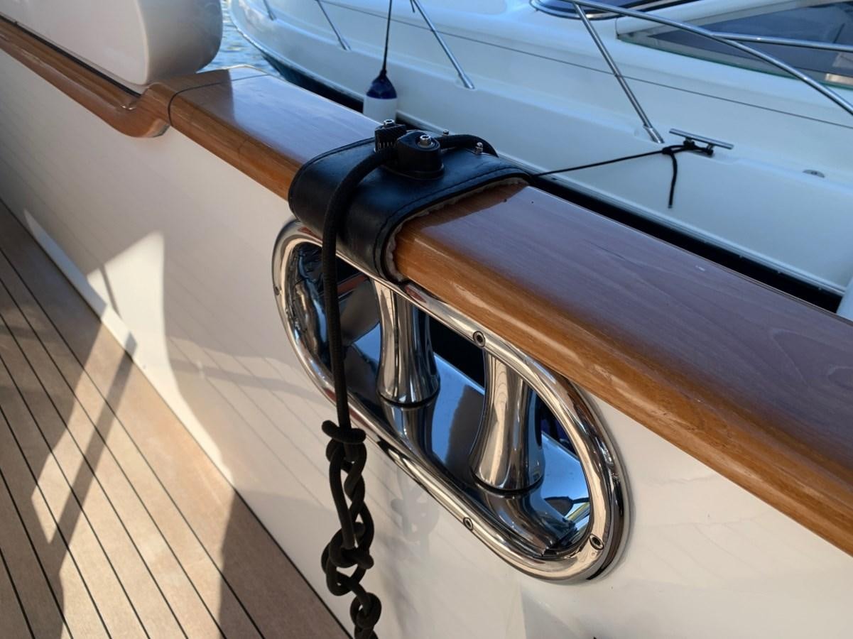 a steering wheel on a wooden surface aboard DREAM ON II Yacht for Sale