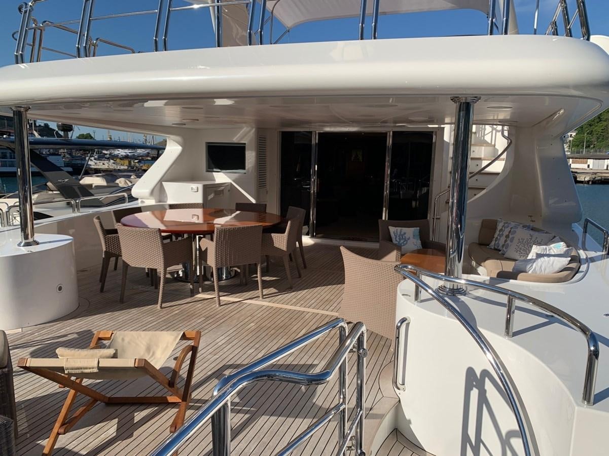 a room with tables and chairs aboard DREAM ON II Yacht for Sale