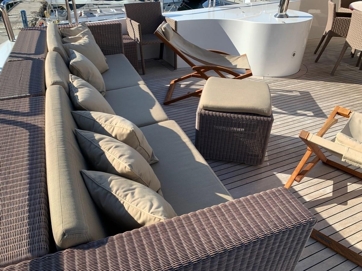 a couch with a table and chairs aboard DREAM ON II Yacht for Sale