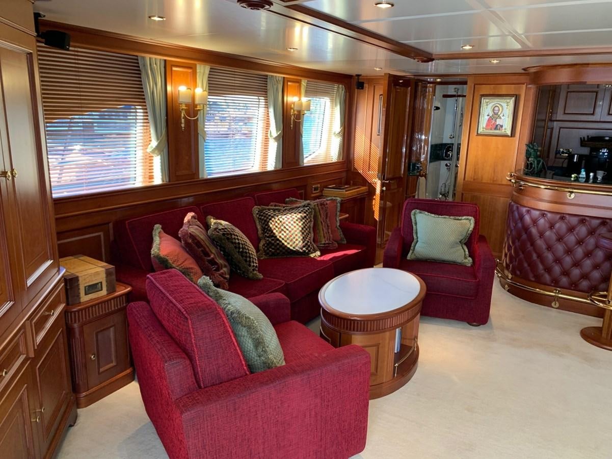a living room with a red couch aboard DREAM ON II Yacht for Sale