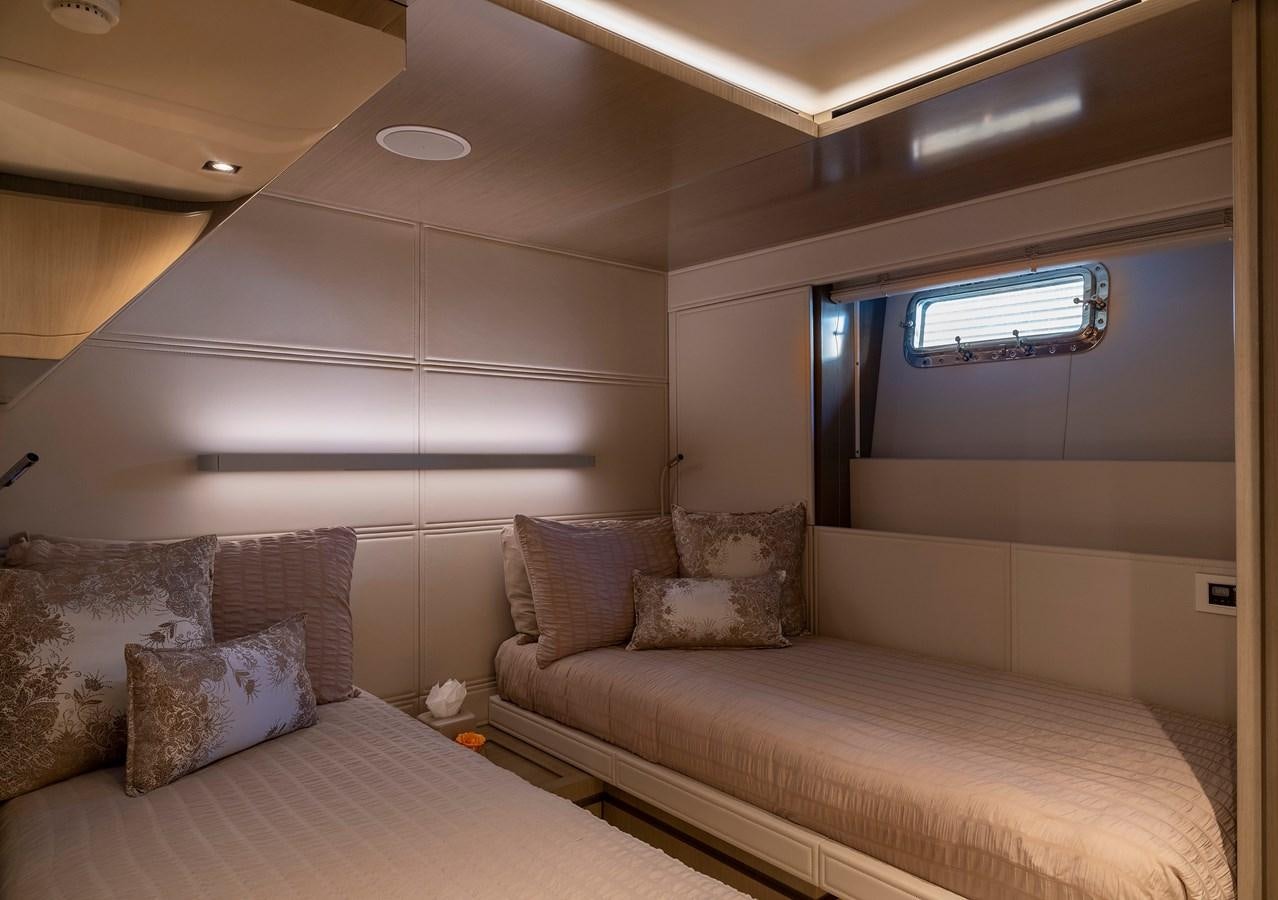 a room with a bed and a window aboard THE PEDDLER Yacht for Sale