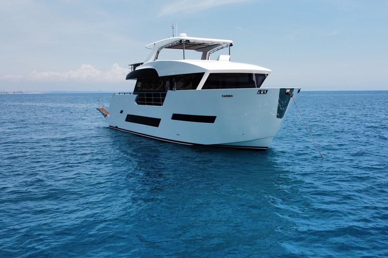 a white boat in the water aboard CARBOYACHT 68 Yacht for Sale