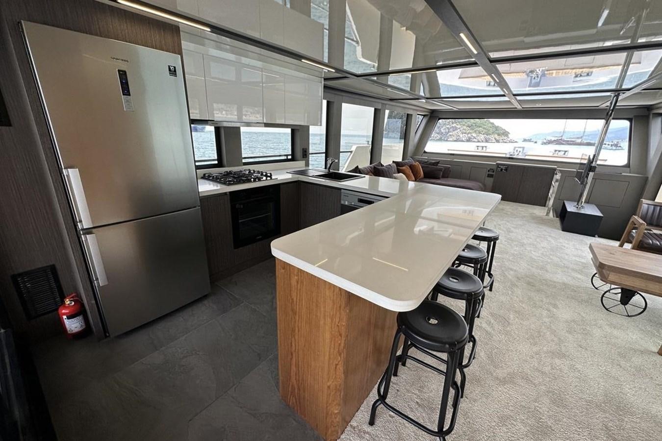 a room with a table and chairs aboard CARBOYACHT 68 Yacht for Sale