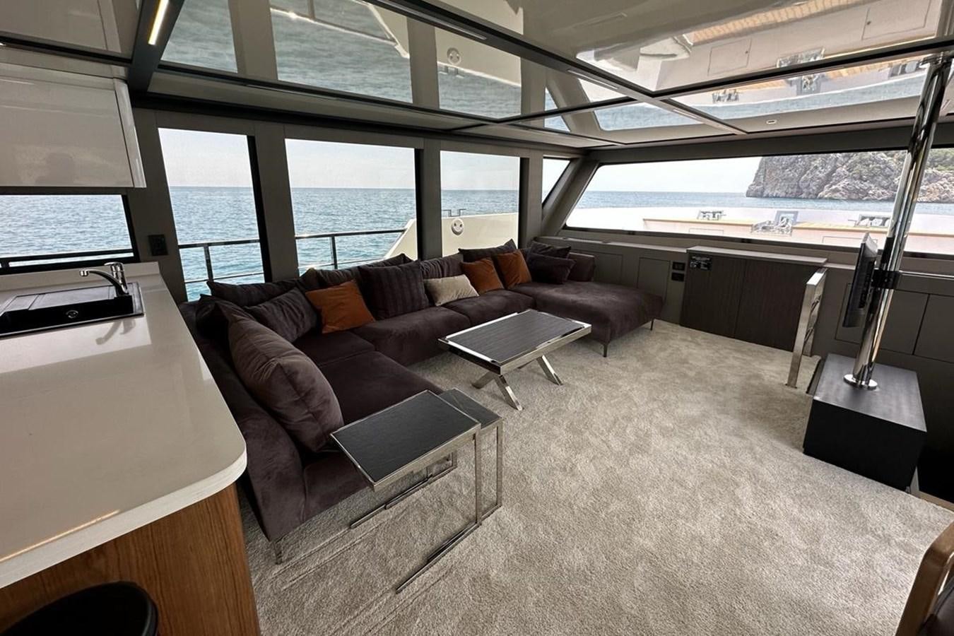 a living room with a large window aboard CARBOYACHT 68 Yacht for Sale