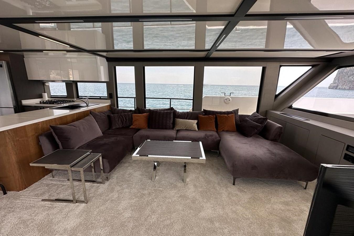 a living room with a couch and a table aboard CARBOYACHT 68 Yacht for Sale