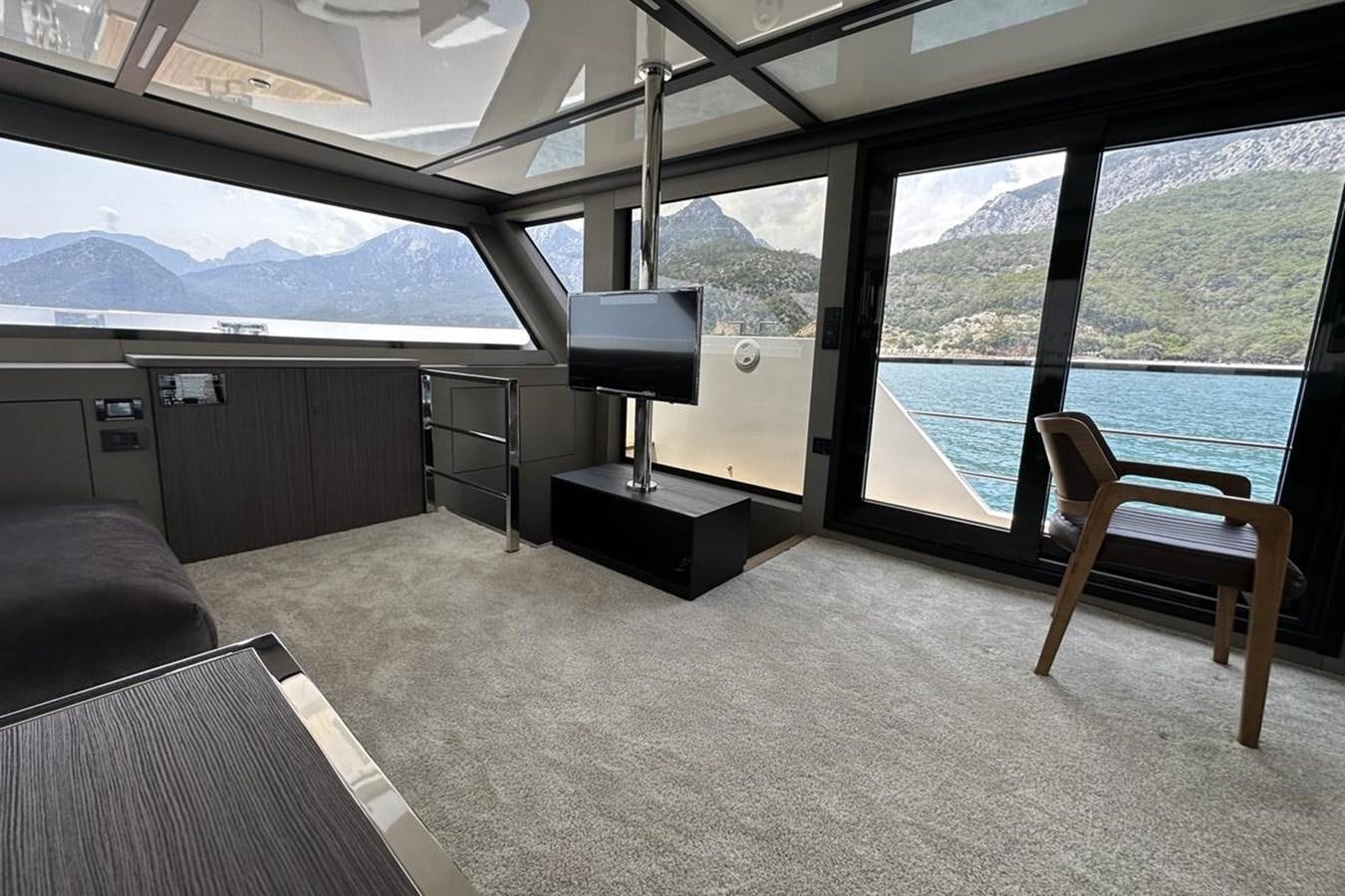 a room with a tv and a couch aboard CARBOYACHT 68 Yacht for Sale
