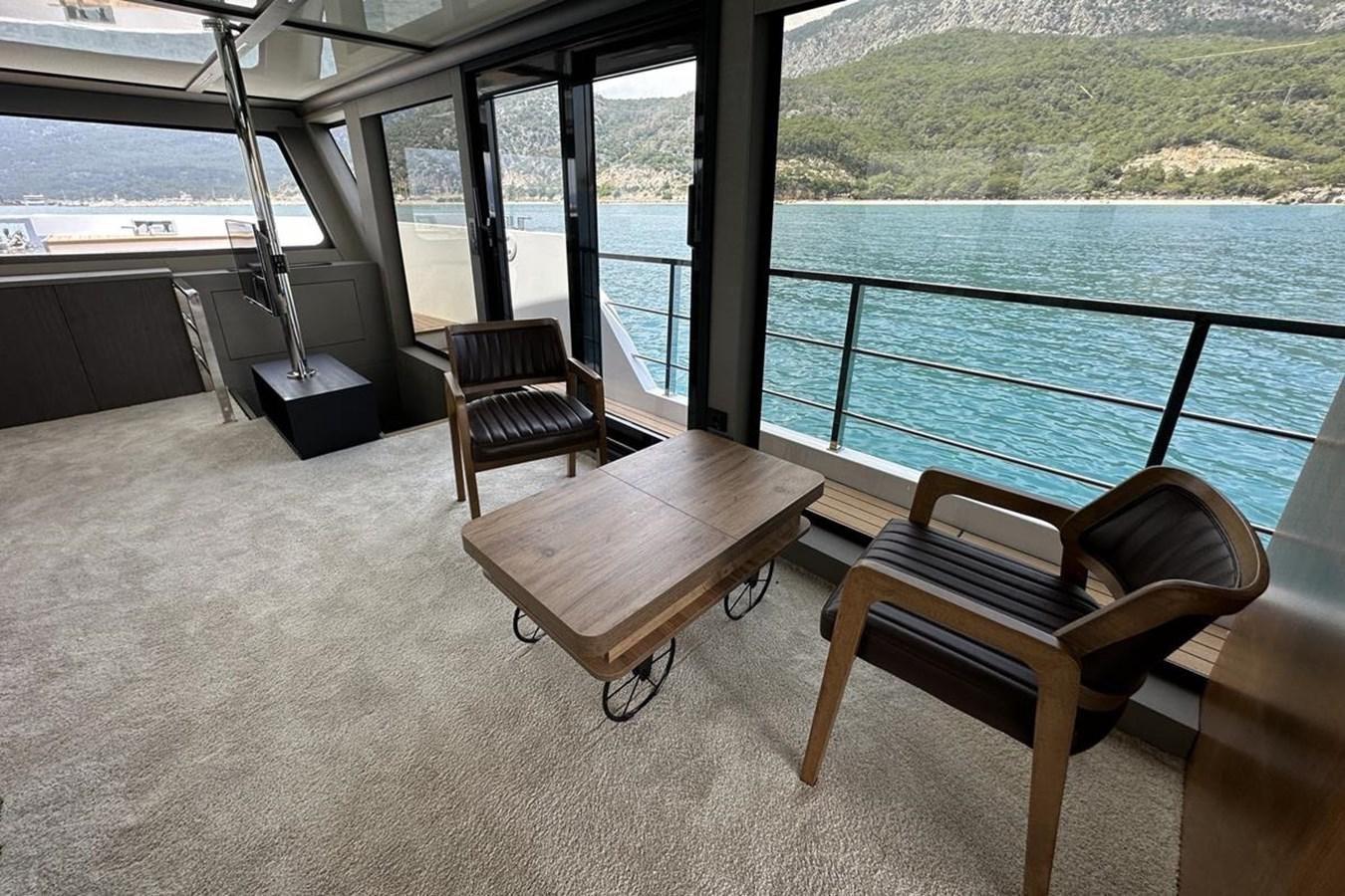a room with a view of the ocean and a bench aboard CARBOYACHT 68 Yacht for Sale