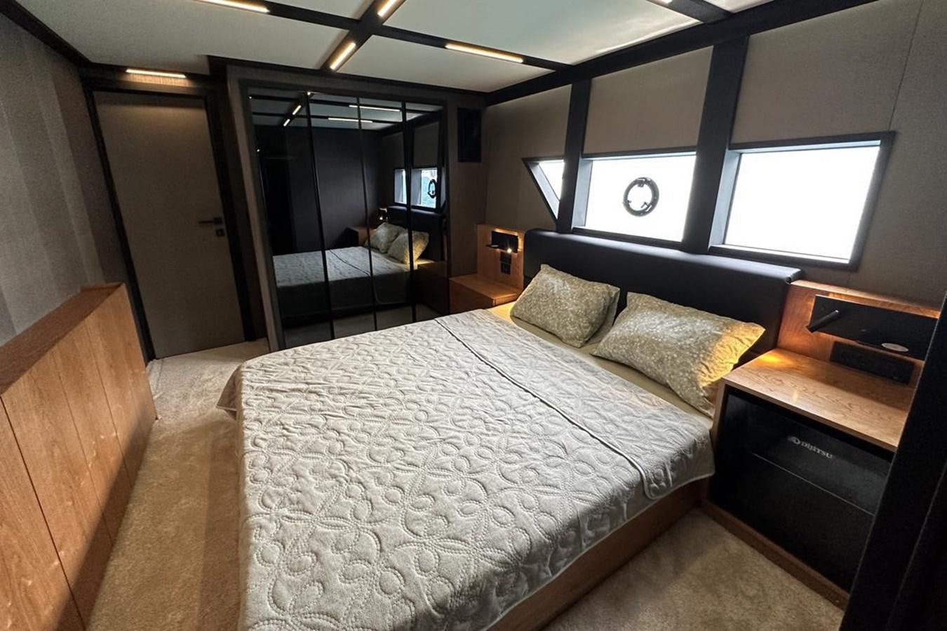a bedroom with a bed and a mirror aboard CARBOYACHT 68 Yacht for Sale
