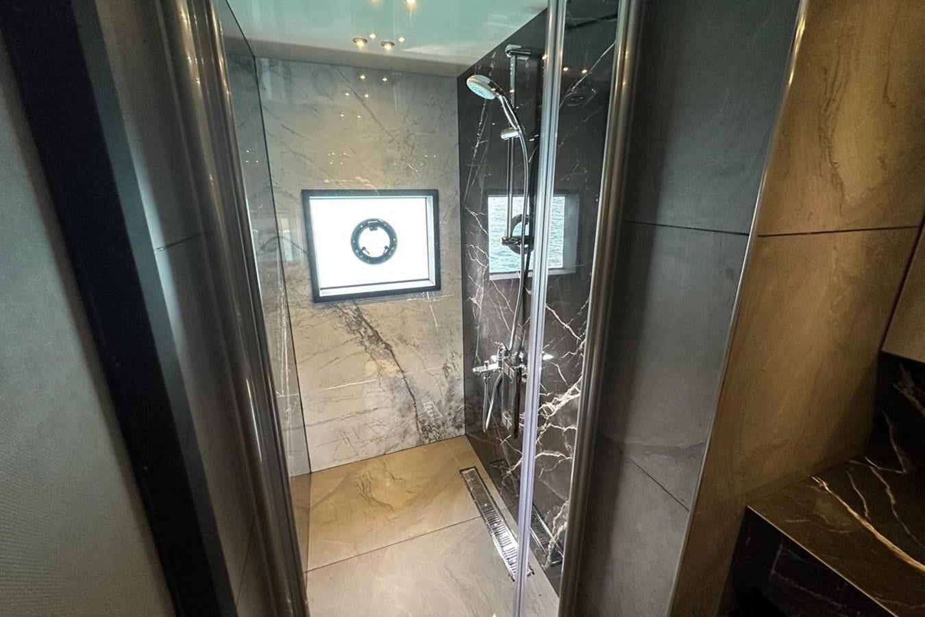 a bathroom with a glass shower aboard CARBOYACHT 68 Yacht for Sale