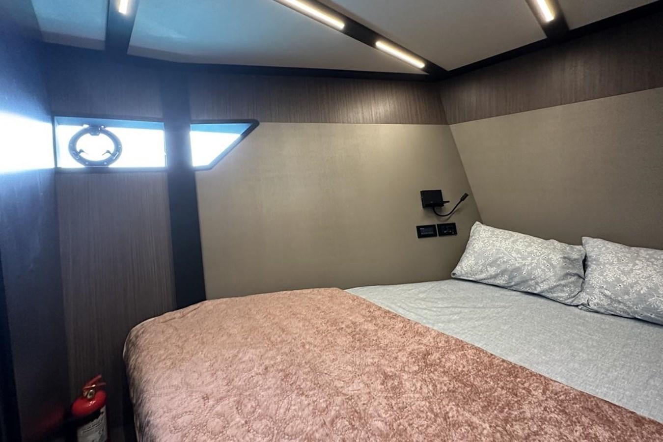 a bed with a white comforter aboard CARBOYACHT 68 Yacht for Sale