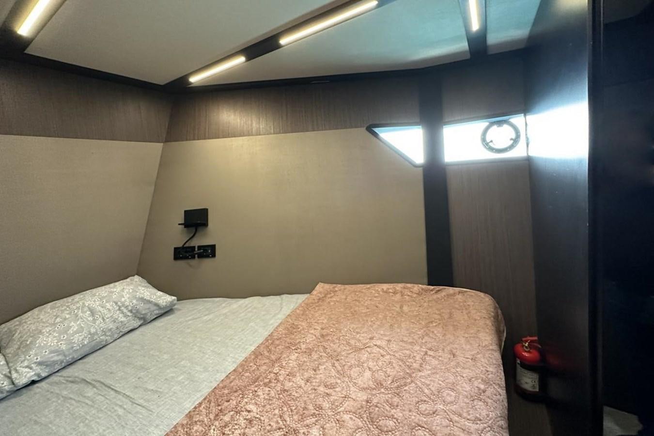 a bed with a white comforter aboard CARBOYACHT 68 Yacht for Sale