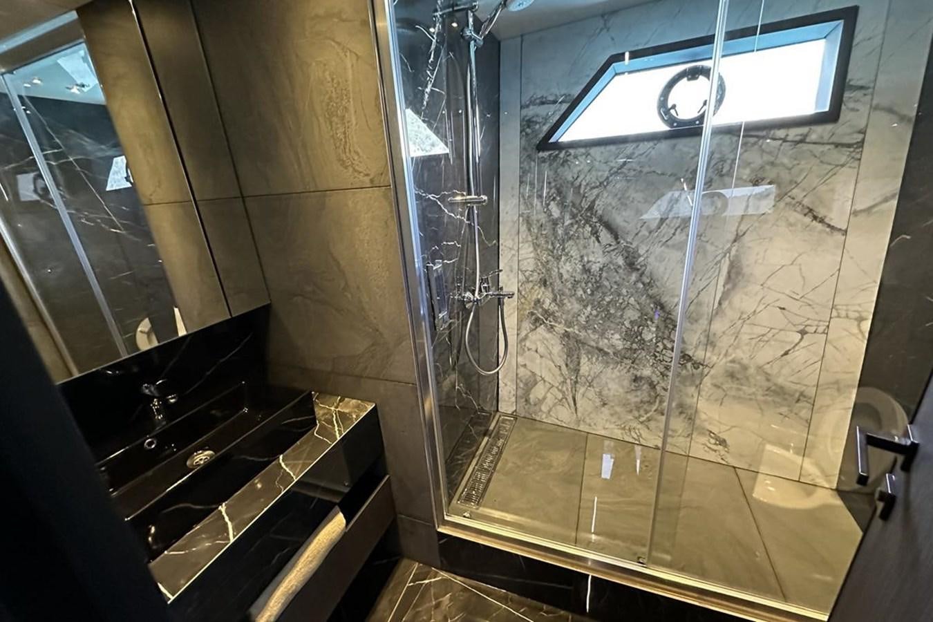 a bathroom with a glass shower aboard CARBOYACHT 68 Yacht for Sale