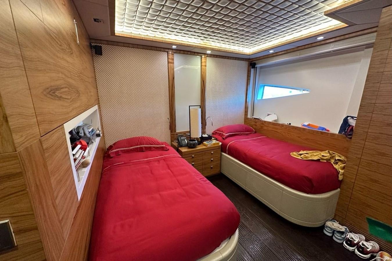 a bedroom with a red bed aboard ELIZAVETA Yacht for Sale
