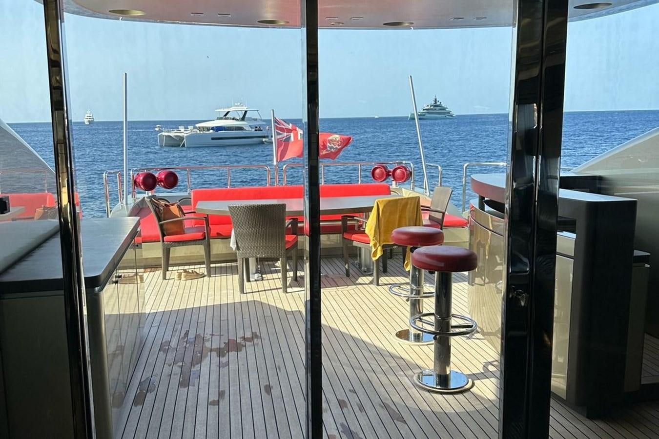 a deck with tables and chairs aboard ELIZAVETA Yacht for Sale