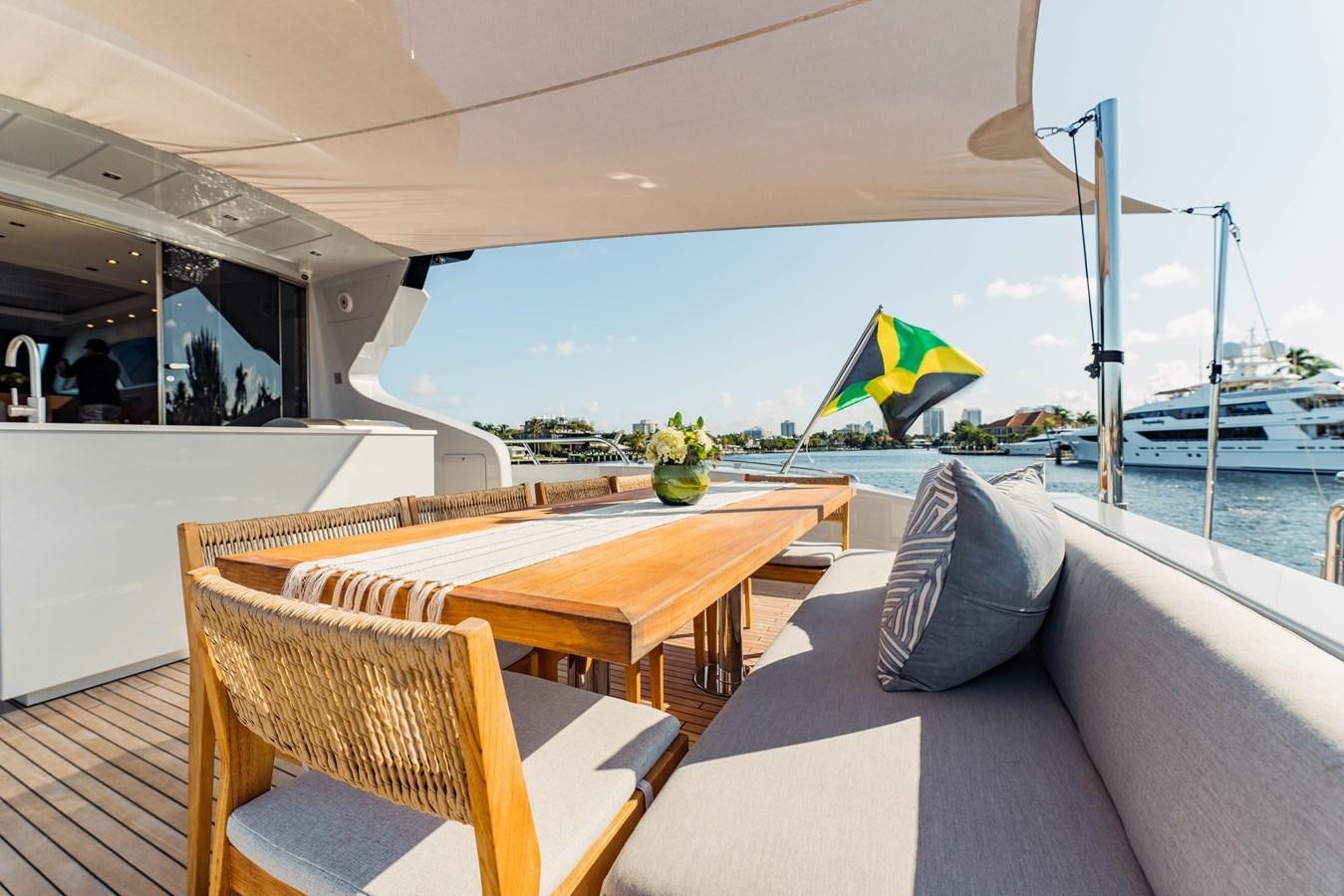 a table and chairs on a deck aboard 7 KNOTS Yacht for Sale