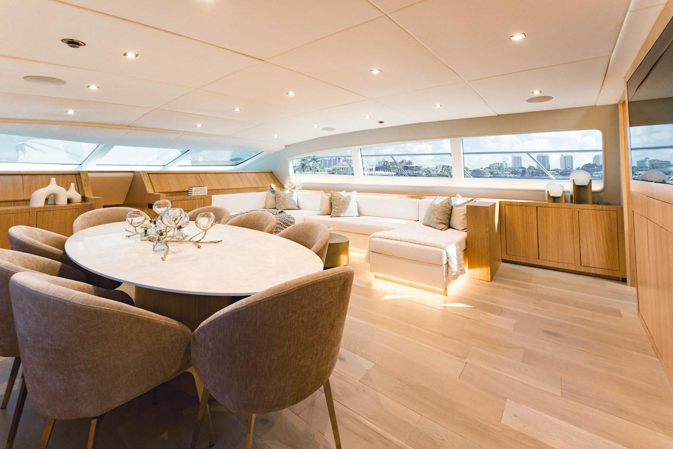 a large living room with a table and chairs aboard 7 KNOTS Yacht for Sale