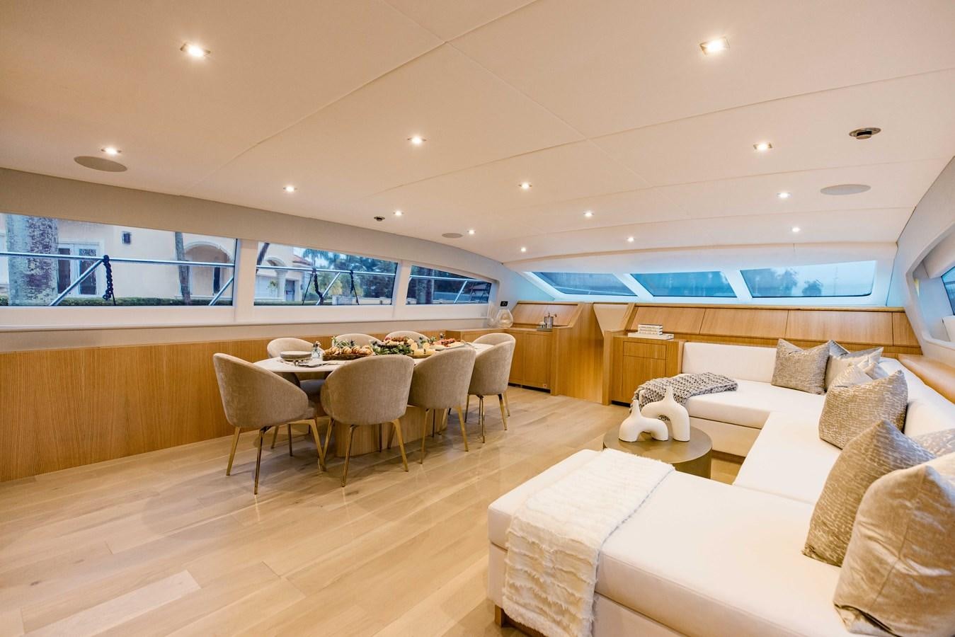 a room with a couch and a table and chairs aboard 7 KNOTS Yacht for Sale