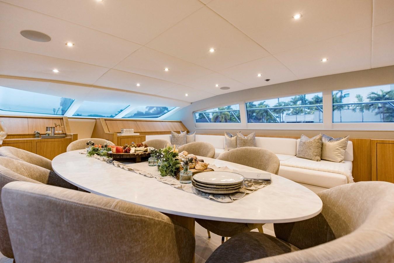 a living room with a table and couches aboard 7 KNOTS Yacht for Sale
