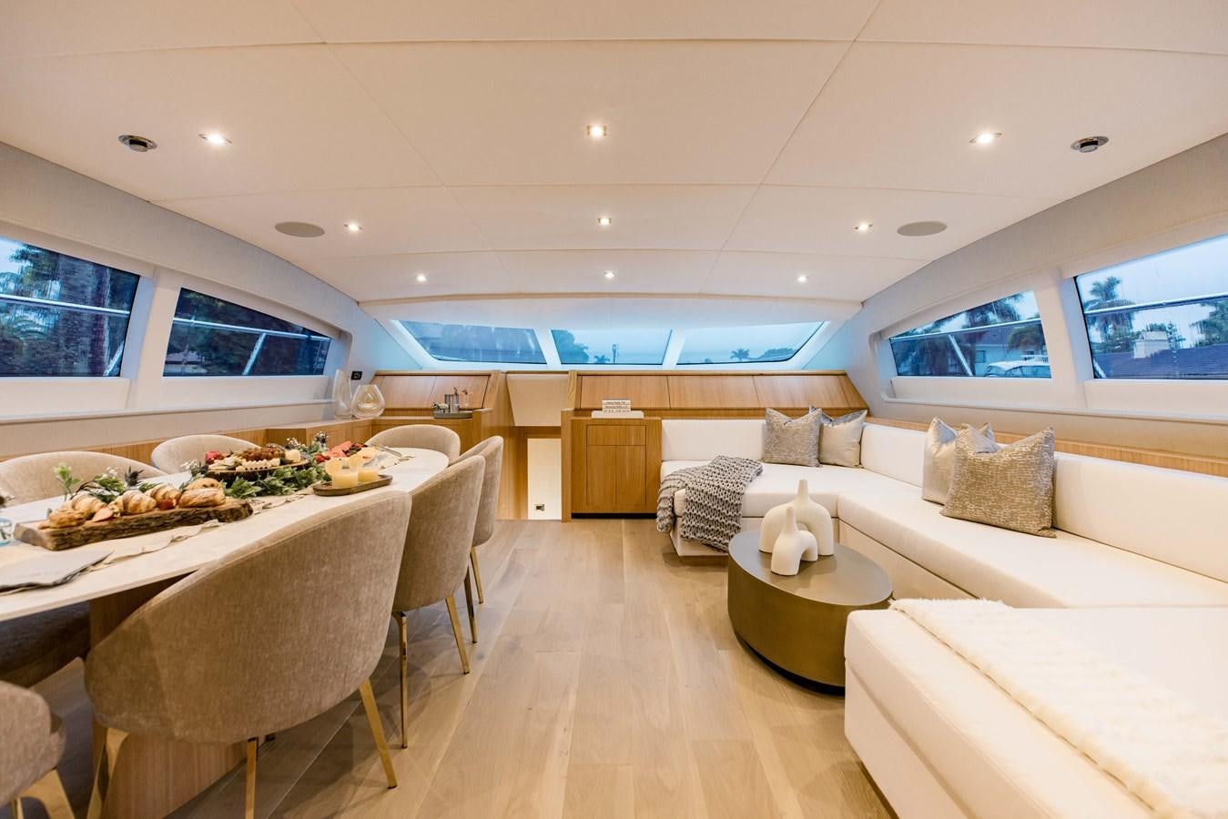 a living room with a table and couches aboard 7 KNOTS Yacht for Sale