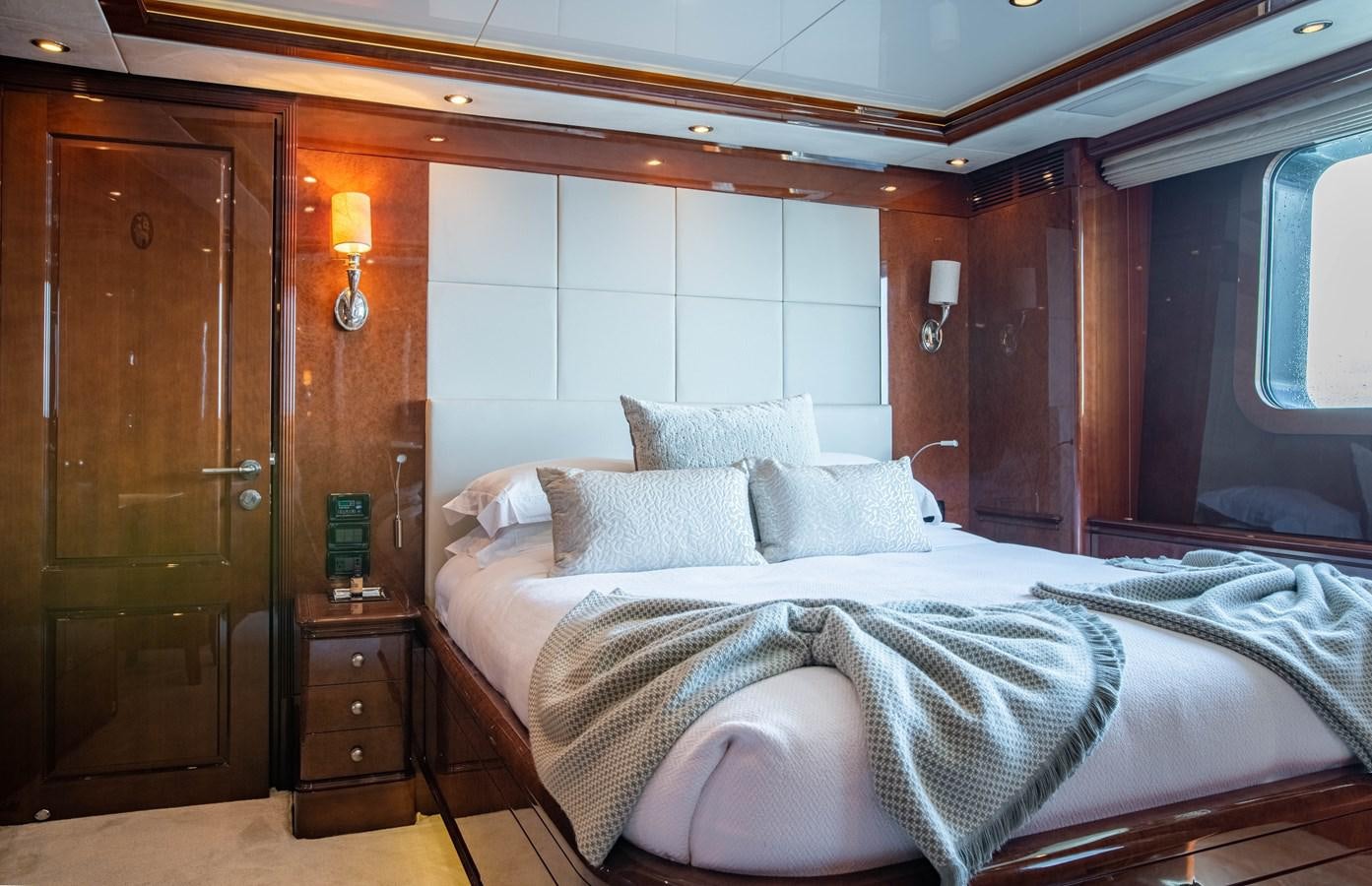 a bed with a white sheet and pillows aboard CHECKMATE Yacht for Sale