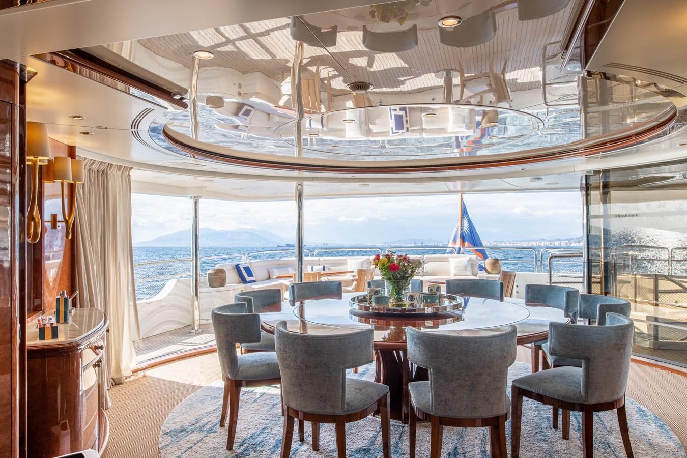 a room with a table chairs and a view of the water aboard CHECKMATE Yacht for Sale